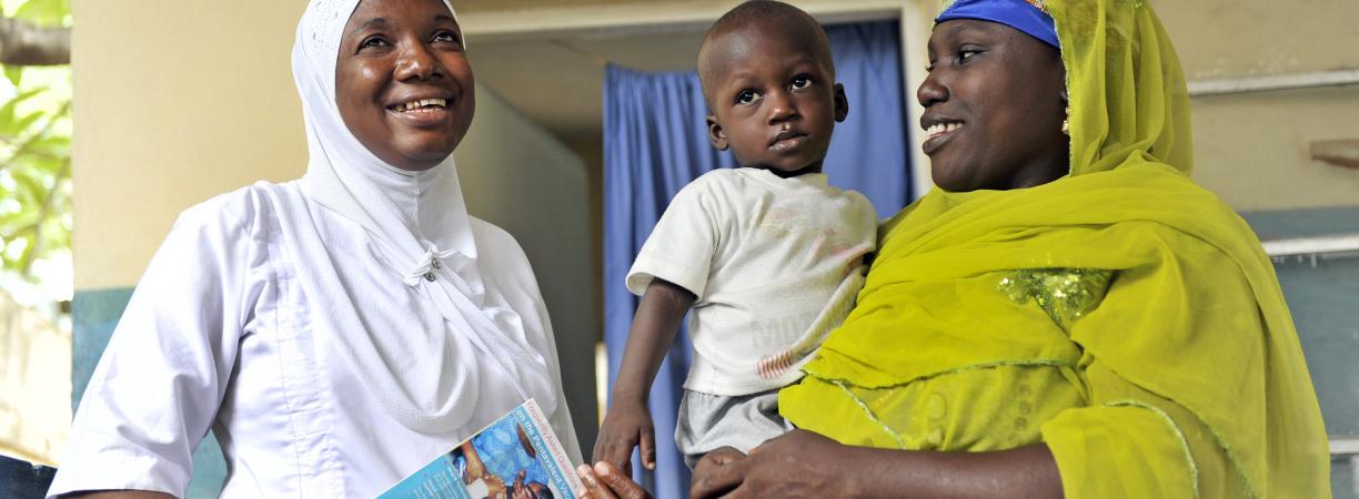 Immunisation health worker with mother and child in Niger State, Nigeria, 